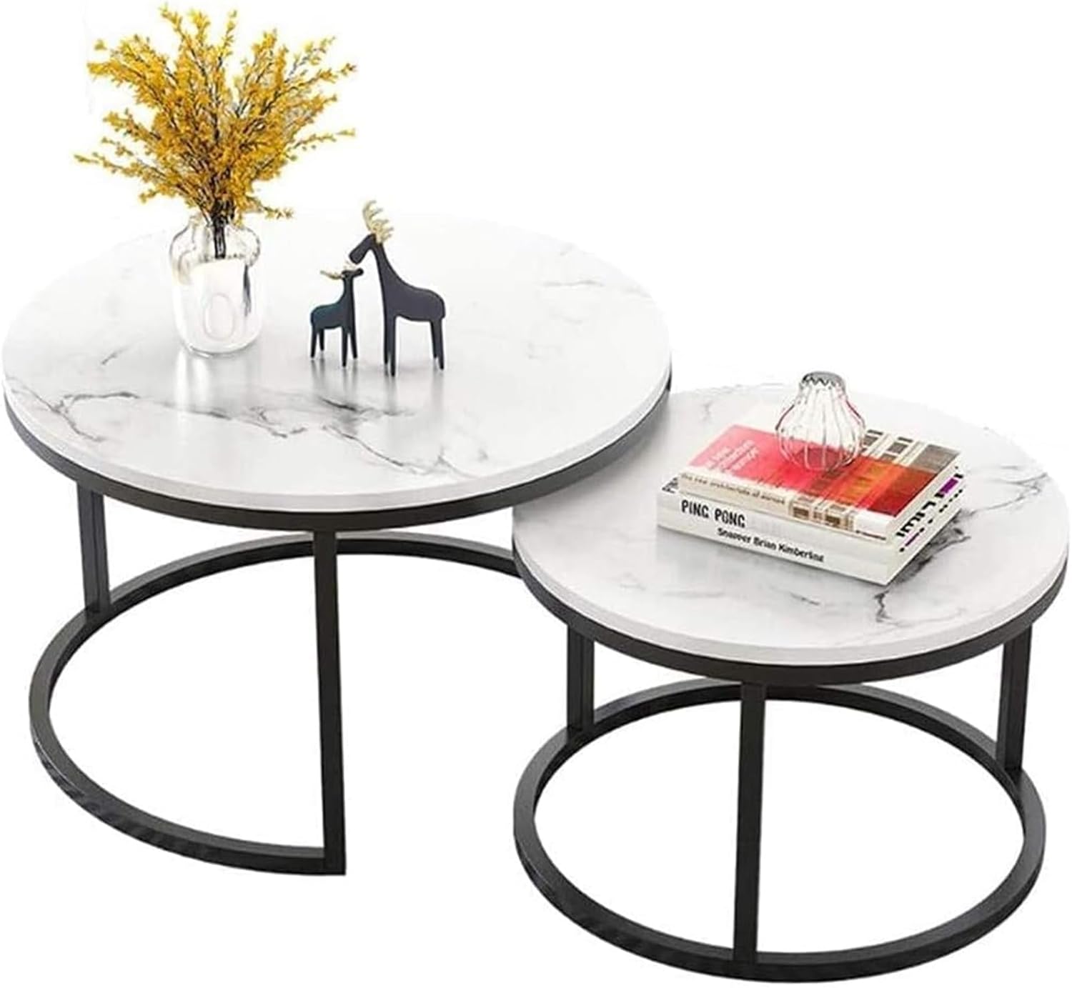 Two round marble coffee tables with decorative items on a white background