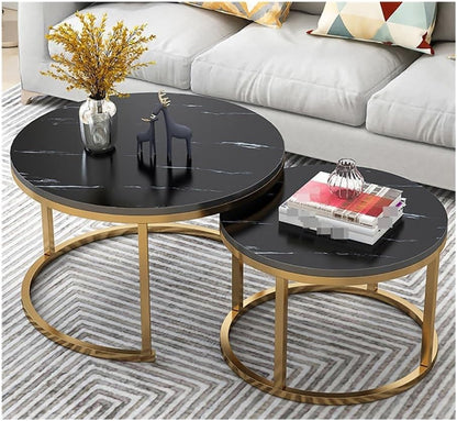 Set of two round coffee tables with black marble tops and gold metal bases in a living room setting.