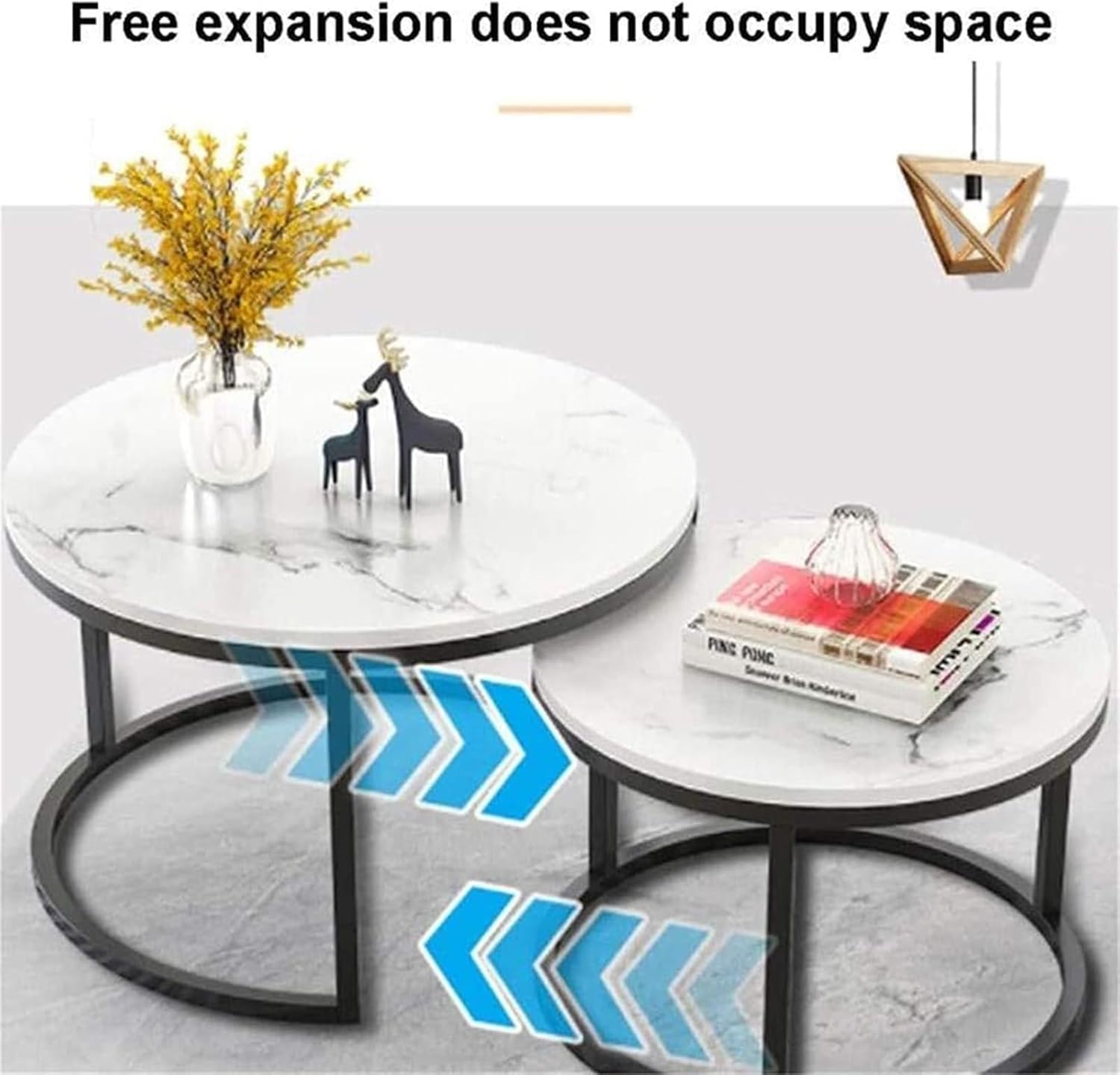 Round marble coffee table with decorative items on a light gray background