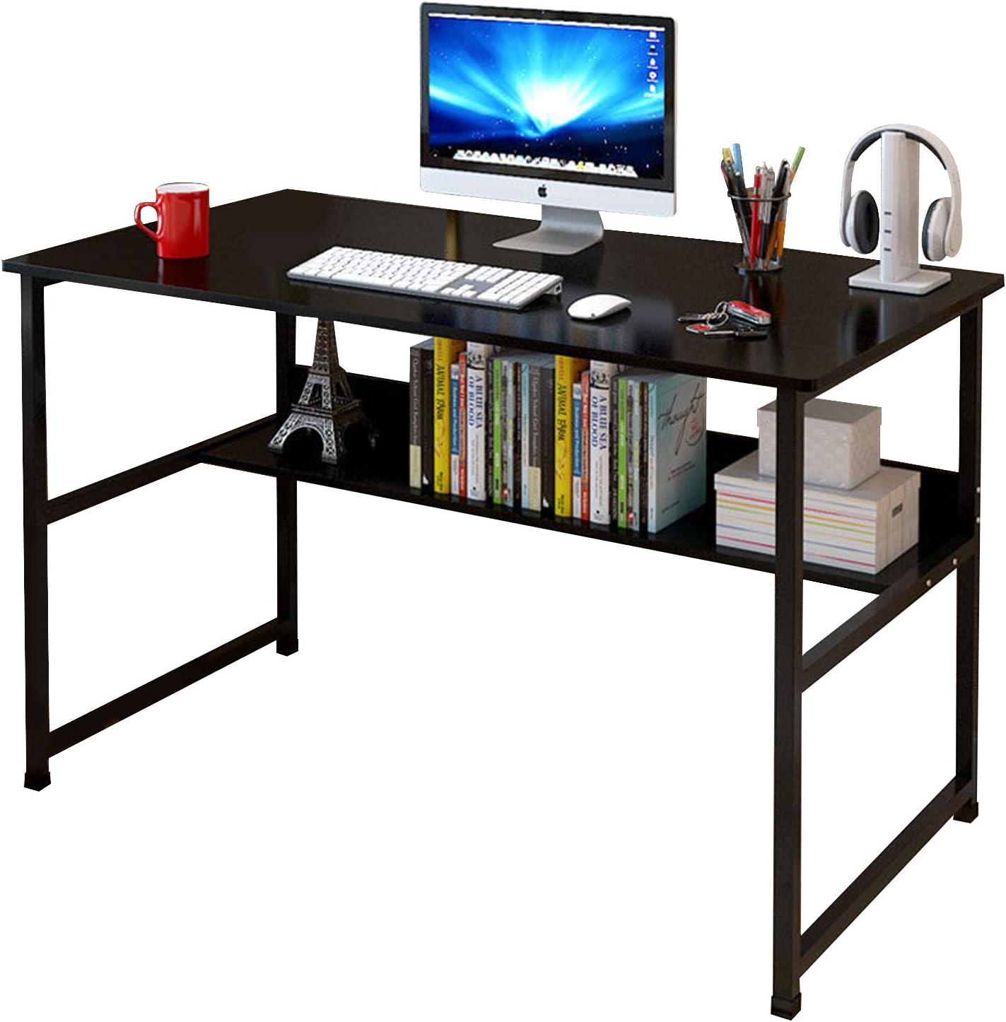 A black computer desk with a metal frame and particleboard tabletop, featuring a shelf with books, a monitor, and other desk accessories.