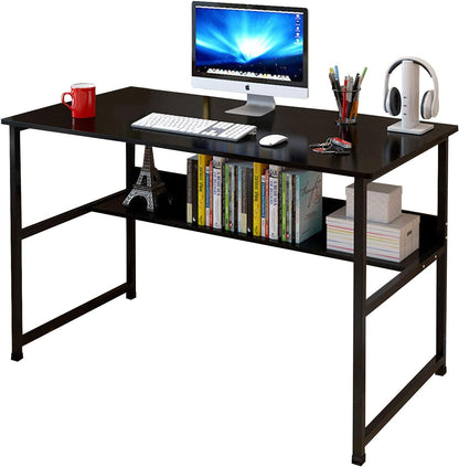 A black computer desk with a metal frame and particleboard tabletop, featuring a shelf with books, a monitor, and other desk accessories.
