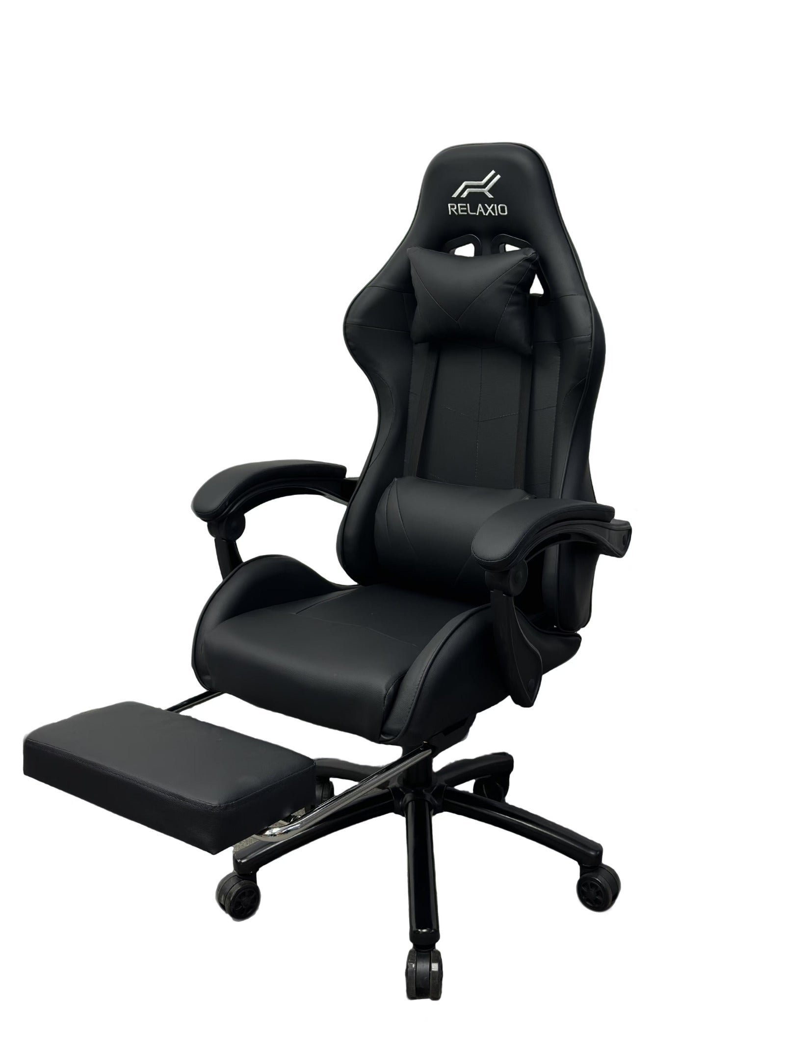 Black and white gaming chair with headrest and footrest, featuring an ergonomic design with a gas lift, cushion, and a steel backrest.