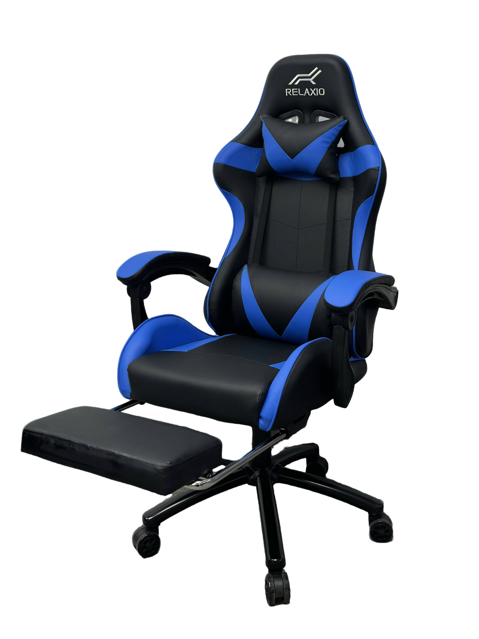 Black and white gaming chair with headrest and footrest, featuring an ergonomic design with a gas lift, cushion, and a steel backrest.
