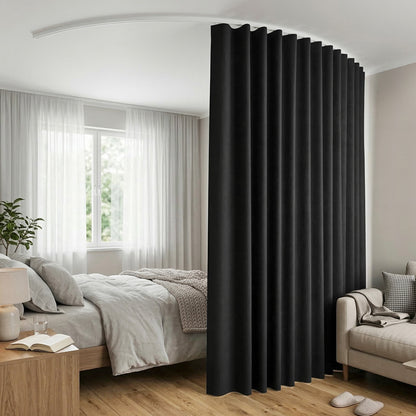 Black curtain in a bedroom setting with bed, lamp, and sofa.