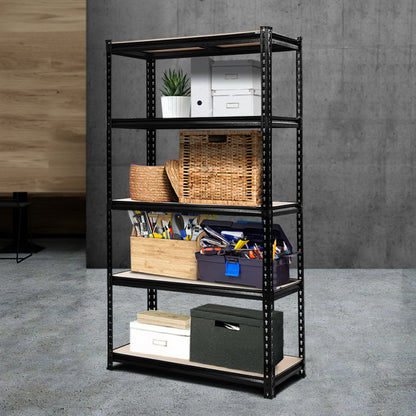 Black metal shelving unit with various items on shelves against a gray wall.